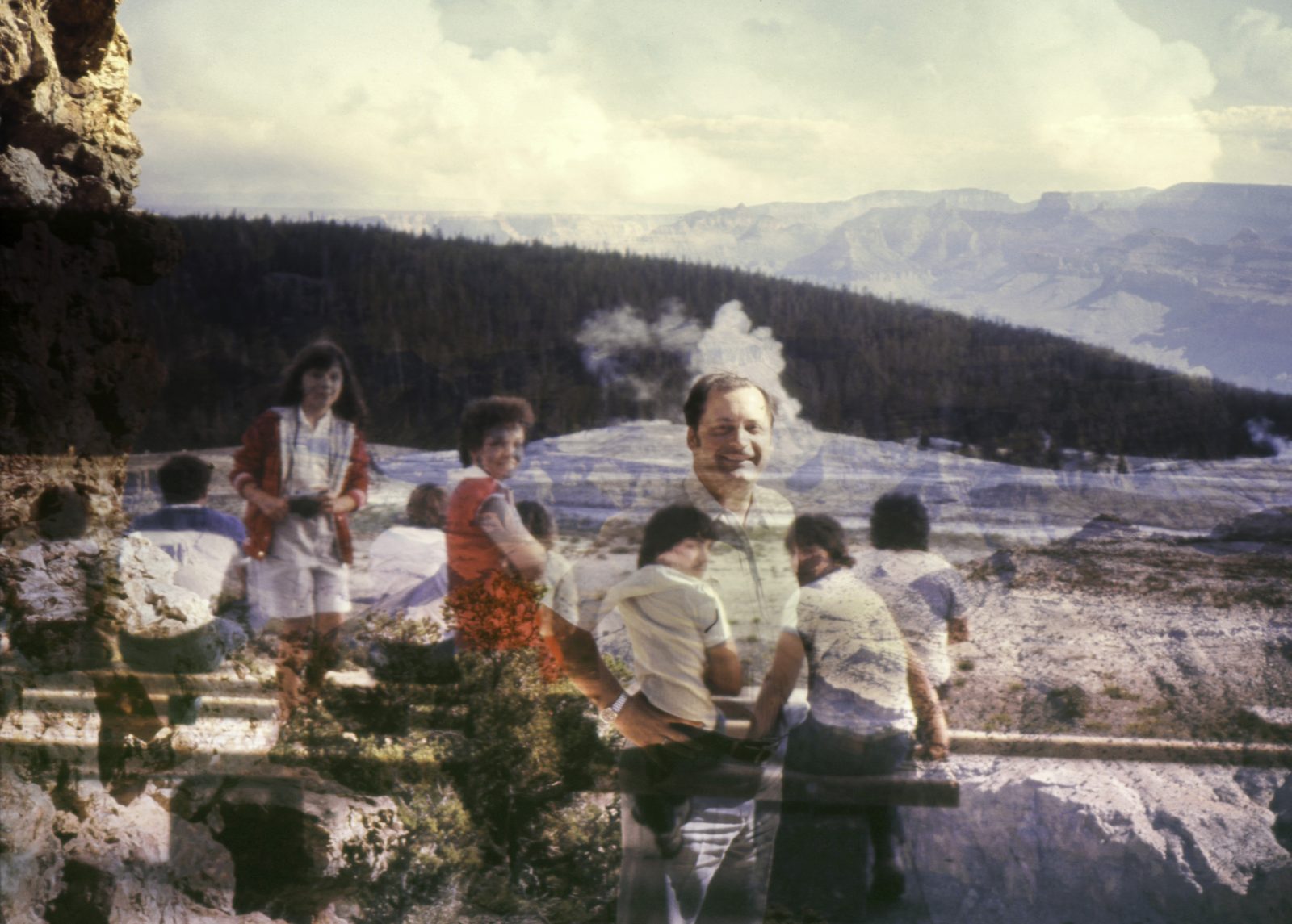 Children and a smiling man layered over a canyon overlook with rising steam, in soft, faded color.