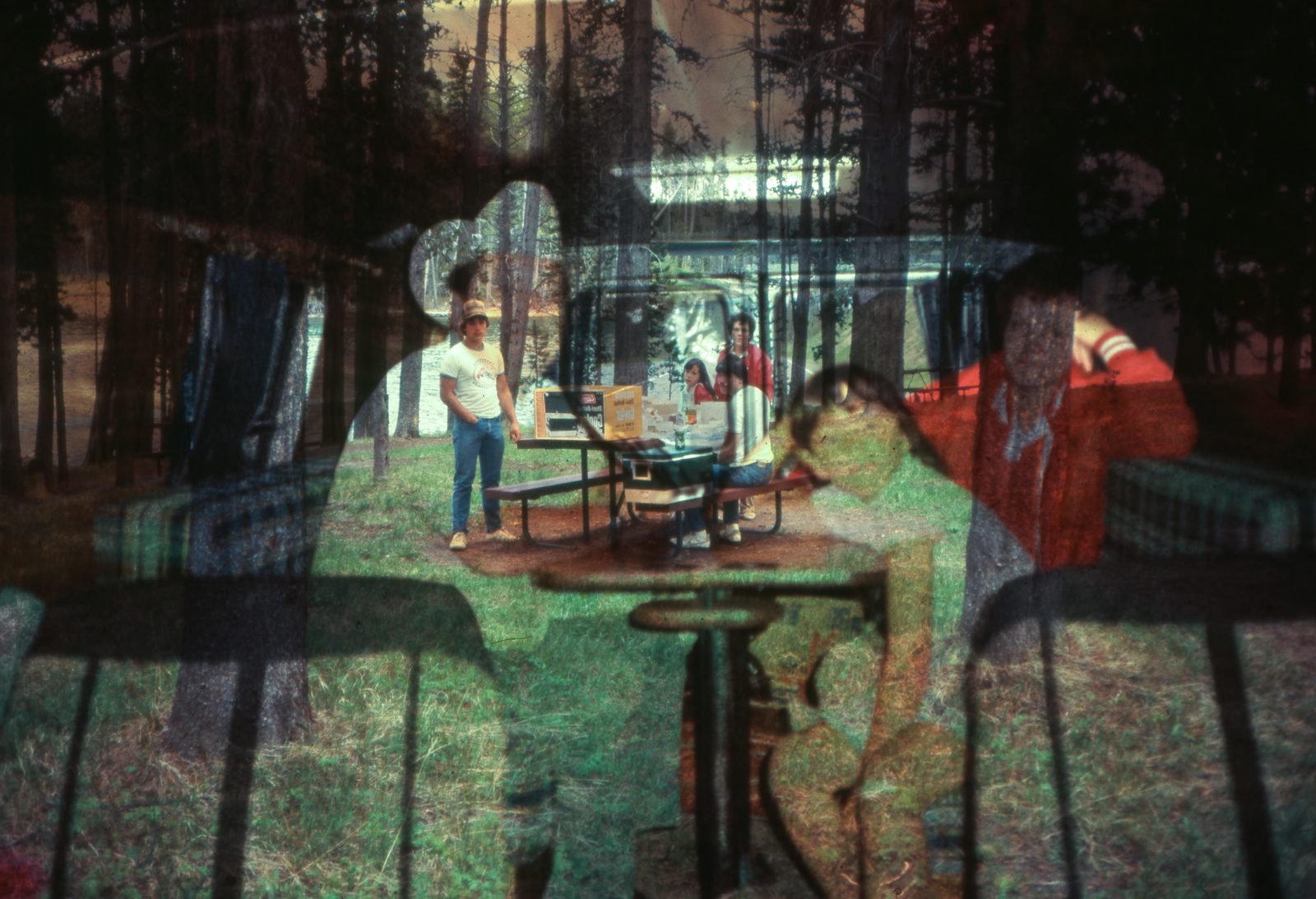 Pine-forest campsite overlaid with a car interior: the artist’s grandmother in red, and their father as a young adult framed in their grandfather’s silhouette.